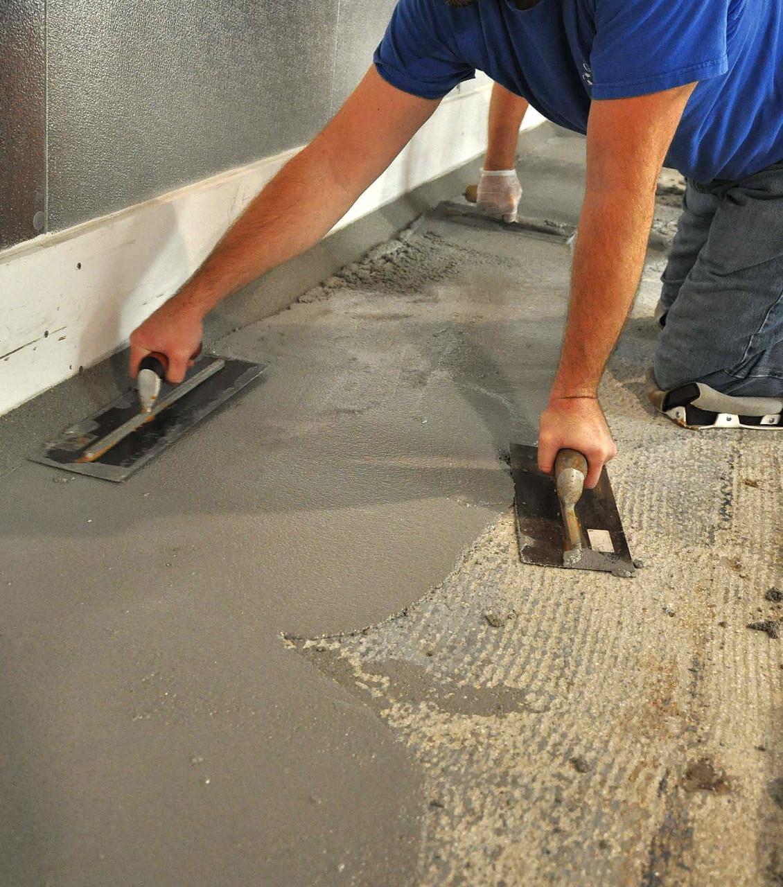 using a trowel to apply floor resurfacer
