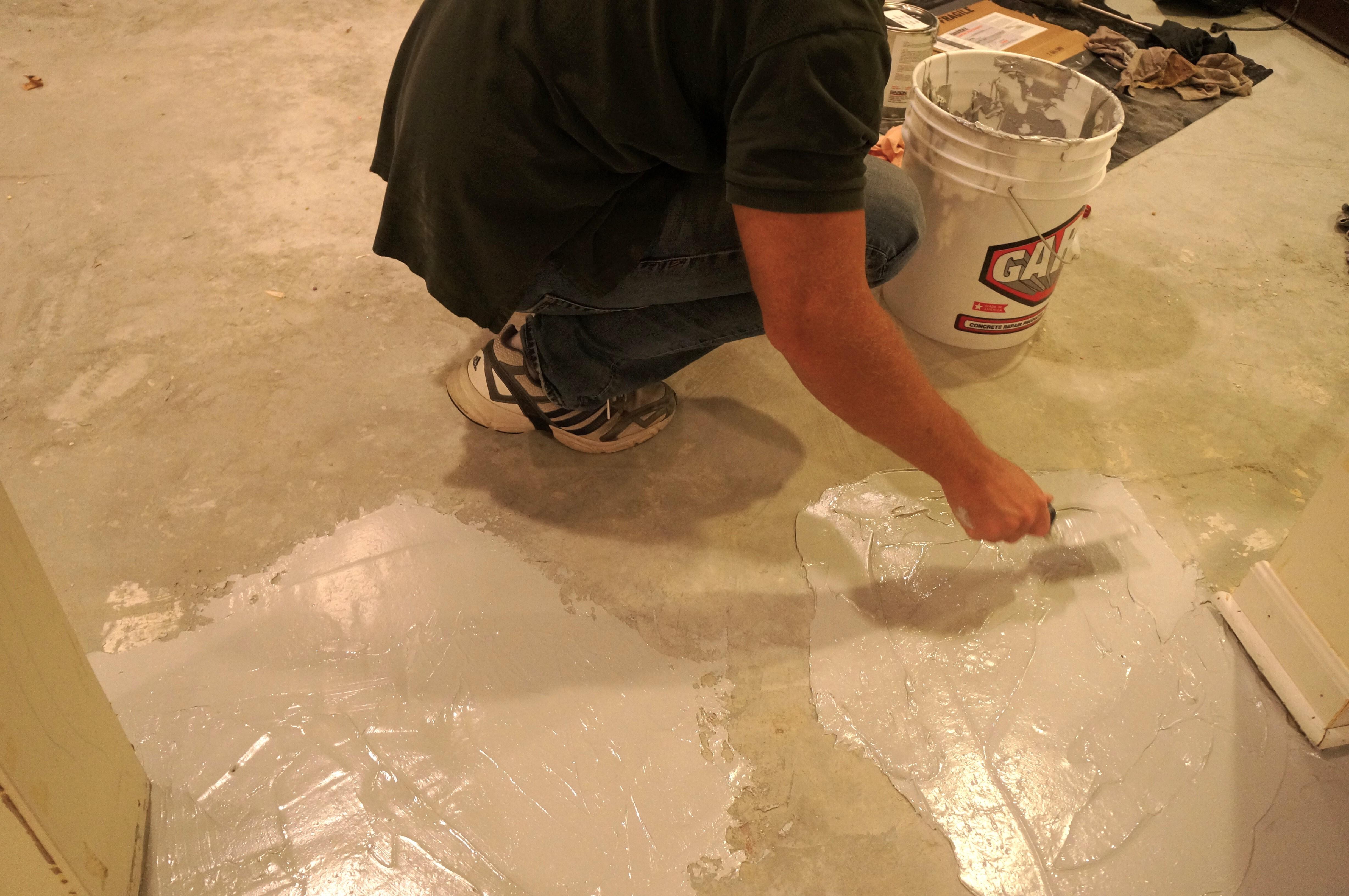 spreading epoxy spackle filler on warehouse floors