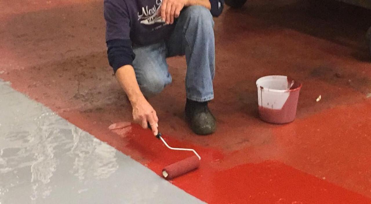 using a roller to apply epoxy floor coating