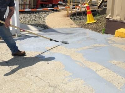 Applying epoxy floor coating with roller