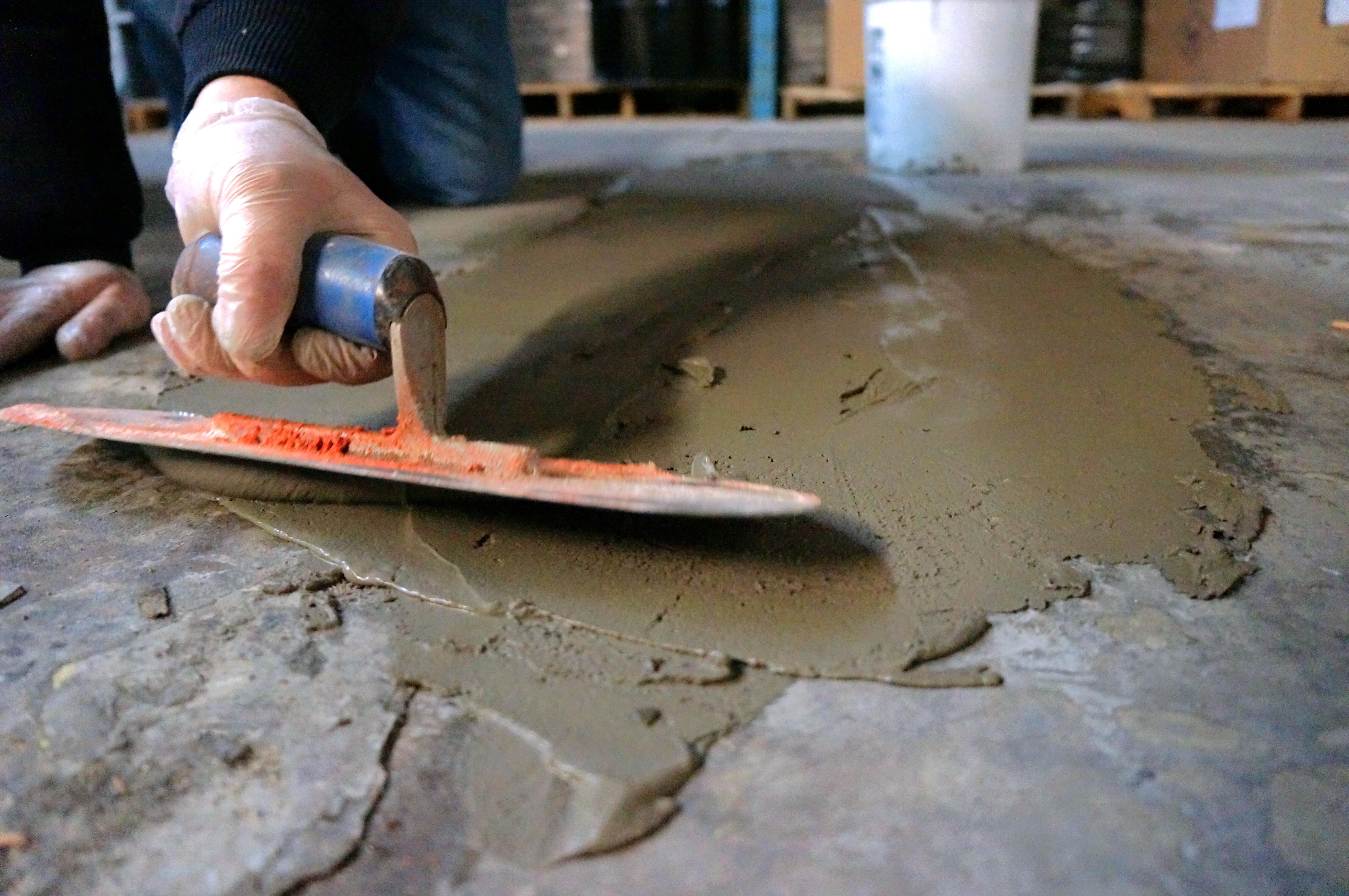 applying floor filler with trowel